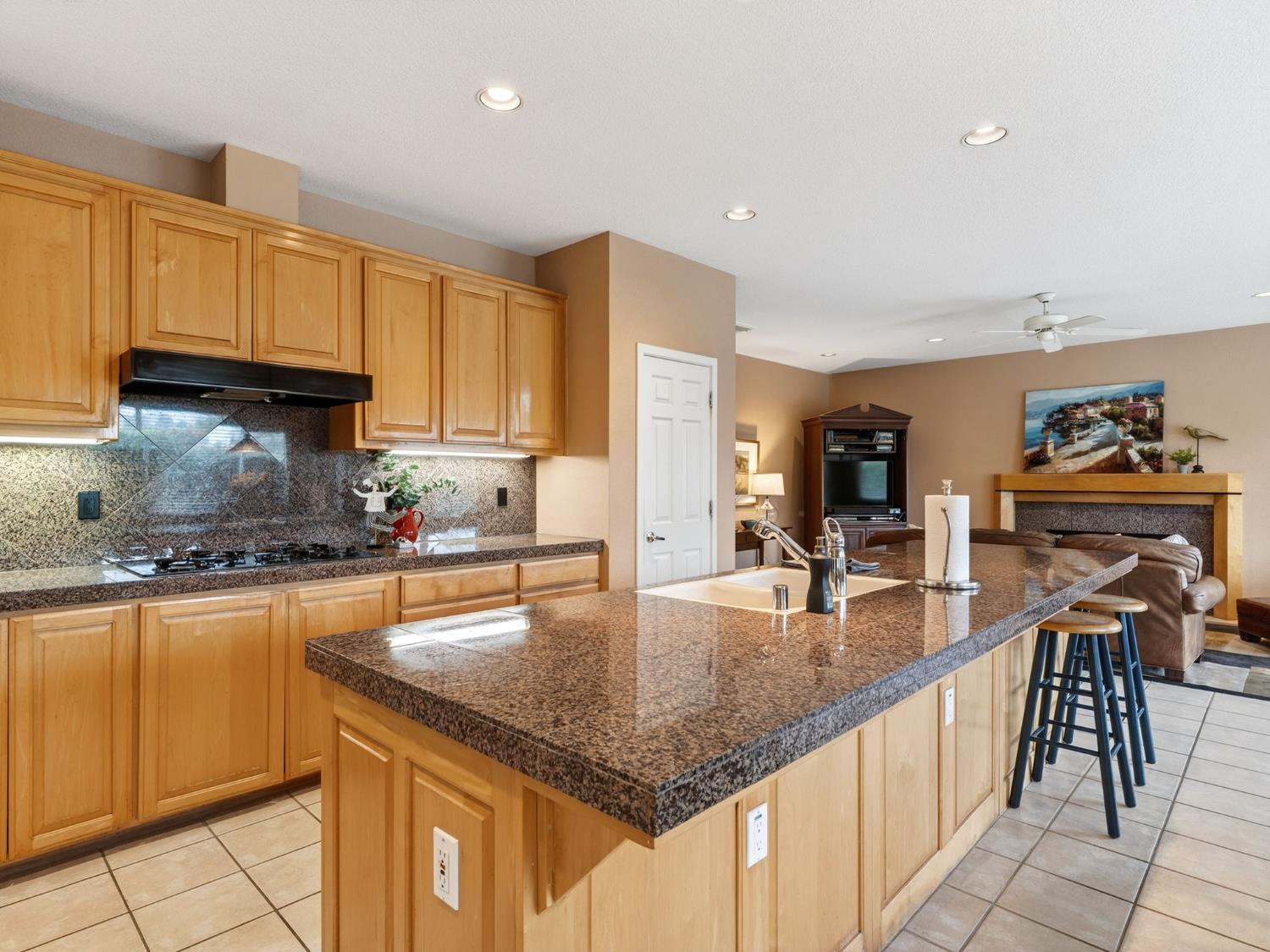 416 Merganser Place Davis, CA 95616 - Photo 14 of 46 a kitchen with granite countertop a sink a counter top space appliances and cabinets
