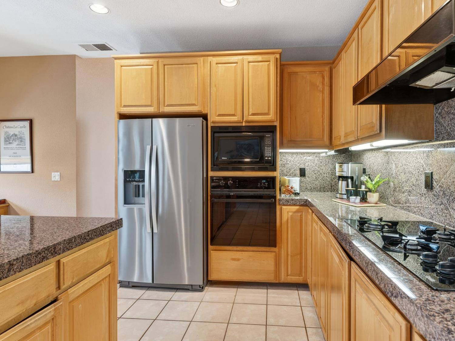 416 Merganser Place Davis, CA 95616 - Photo 16 of 46 a kitchen with stainless steel appliances granite countertop a refrigerator and a sink
