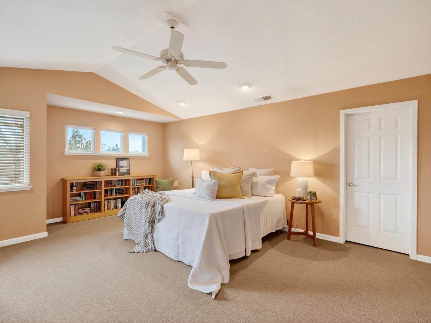 416 Merganser Place Davis, CA 95616 - Photo 22 of 46 a spacious bedroom with a bed and a chandelier