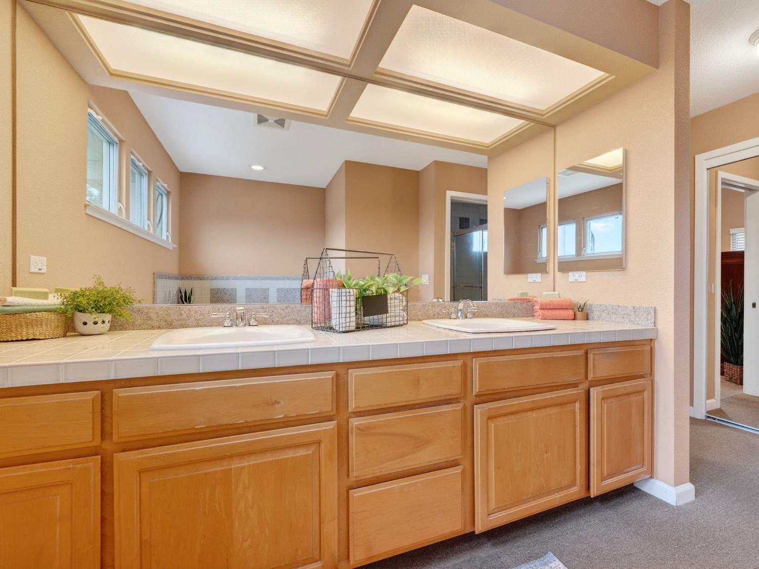 416 Merganser Place Davis, CA 95616 - Photo 26 of 46 a bathroom with a sink and a mirror