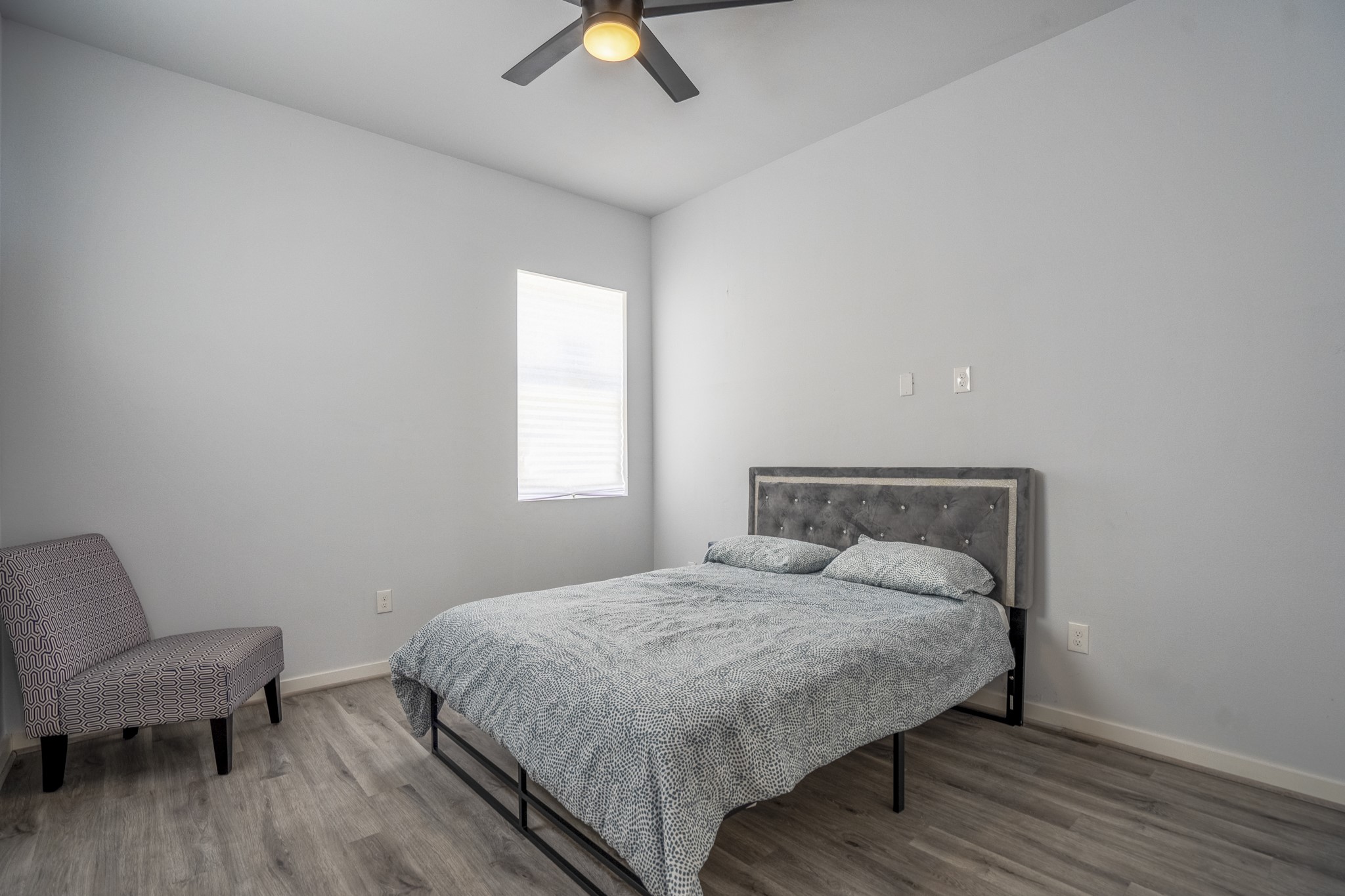 2518 Cleburne Street Houston, TX 77004 - Photo 23 of 24 a bedroom with a bed and a chair
