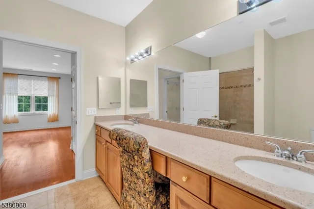a spacious bathroom with a granite countertop tub sink and mirror