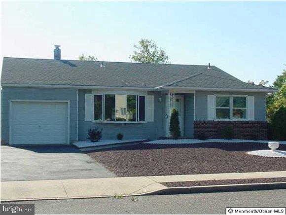 32 Mapleton Road Toms River, NJ 08757 - Photo 1 of 1 a front view of a house with a yard and garage