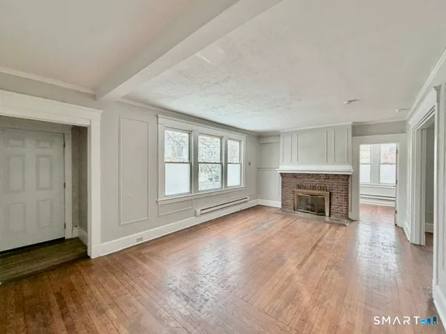 wooden floor in an empty room with a window