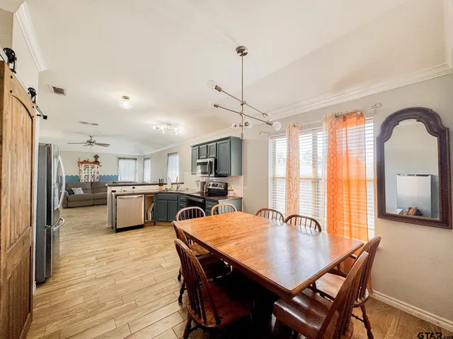 a view of a dining room with furniture and a large window