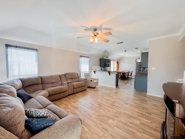 a living room with furniture and kitchen view