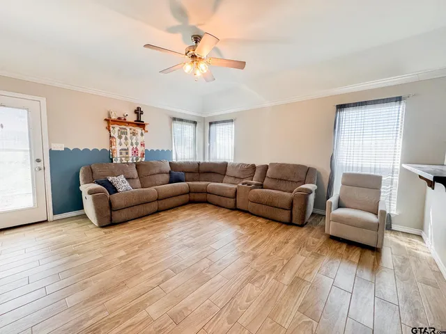 a living room with furniture and a wooden floor
