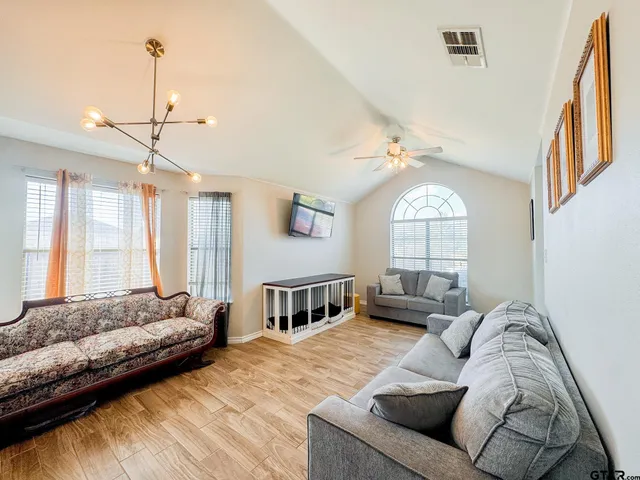 a bedroom with furniture and a large window