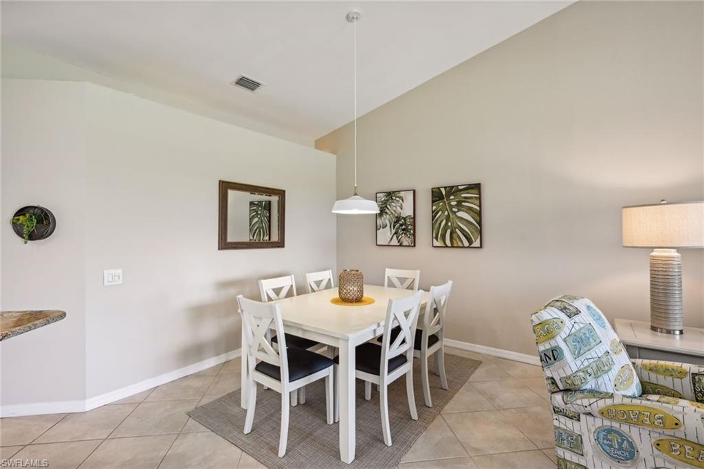 9030 Spring Run Boulevard, Unit 508 Estero, FL 34135 - Photo 14 of 50 a view of a dining room with furniture