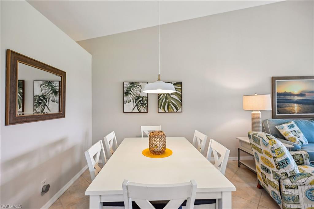9030 Spring Run Boulevard, Unit 508 Estero, FL 34135 - Photo 16 of 50 a view of a dining room with furniture and wooden floor
