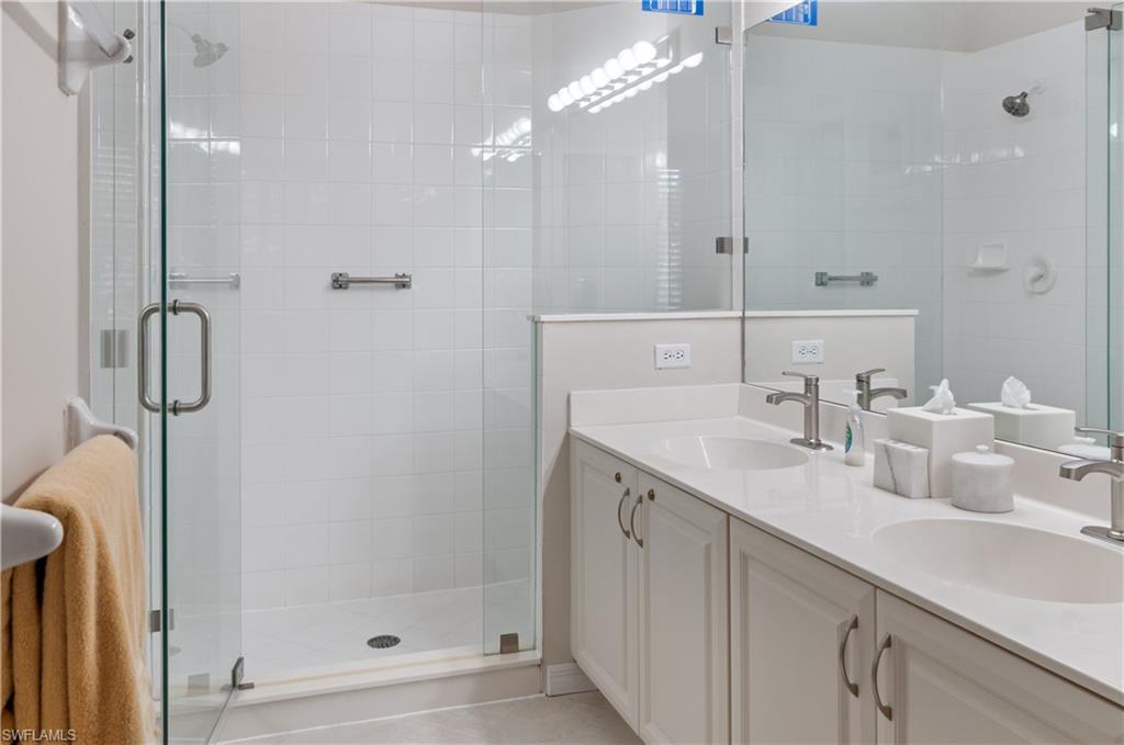 9030 Spring Run Boulevard, Unit 508 Estero, FL 34135 - Photo 26 of 50 a bathroom with a double vanity sink mirror and shower