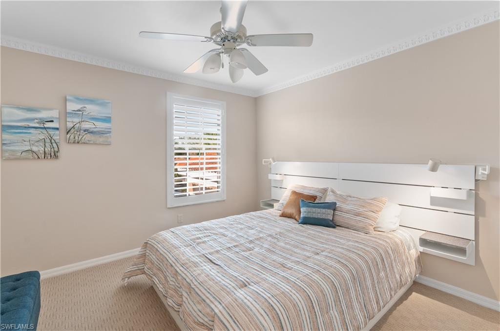 9030 Spring Run Boulevard, Unit 508 Estero, FL 34135 - Photo 28 of 50 a bedroom with a large bed and a chandelier