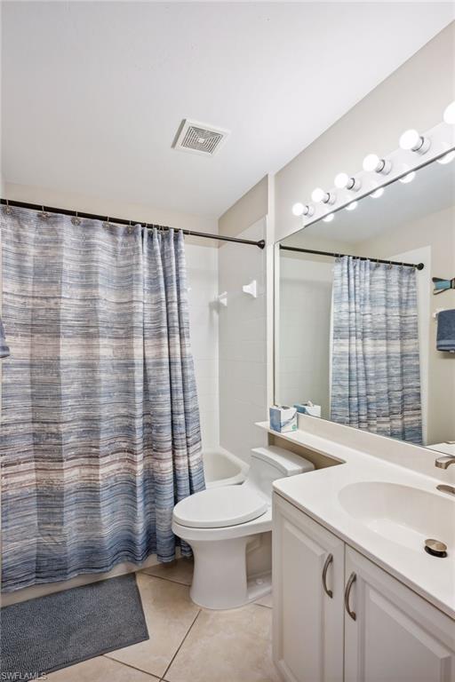 9030 Spring Run Boulevard, Unit 508 Estero, FL 34135 - Photo 29 of 50 a bathroom with a sink a toilet and shower