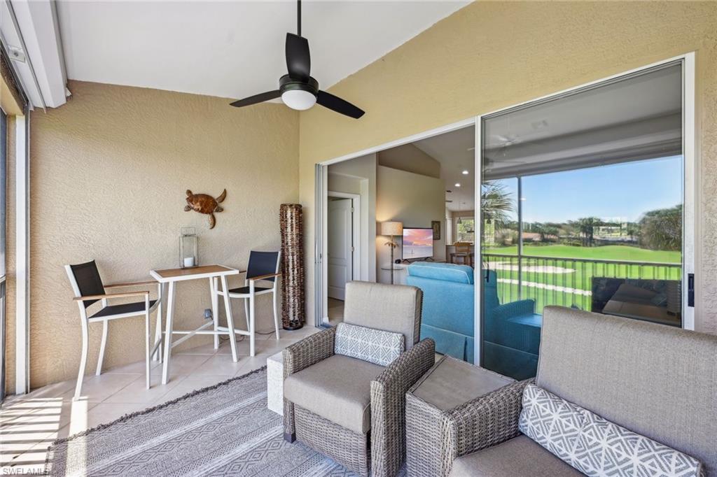 9030 Spring Run Boulevard, Unit 508 Estero, FL 34135 - Photo 31 of 50 a living room with furniture and a large window