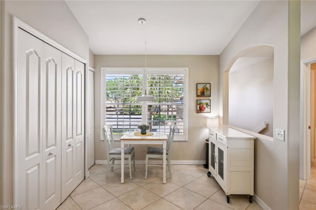 9030 Spring Run Boulevard, Unit 508 Estero, FL 34135 - Photo 9 of 50 a dining room with furniture and a window