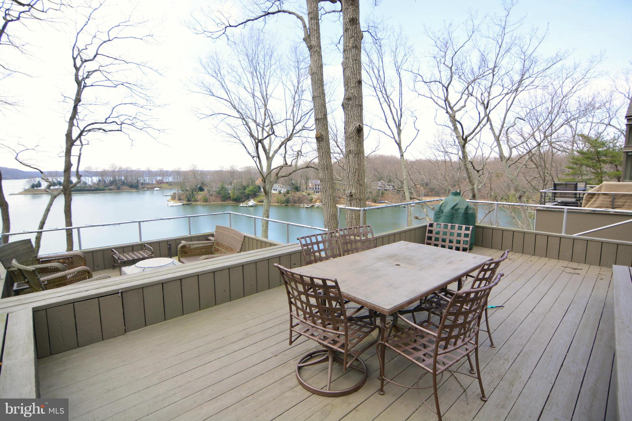 1252 Fenwick Garth Arnold, MD 21012 - Photo 22 of 30 a balcony with wooden floor table and chairs
