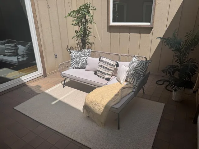 a spacious bedroom with a bed and chair