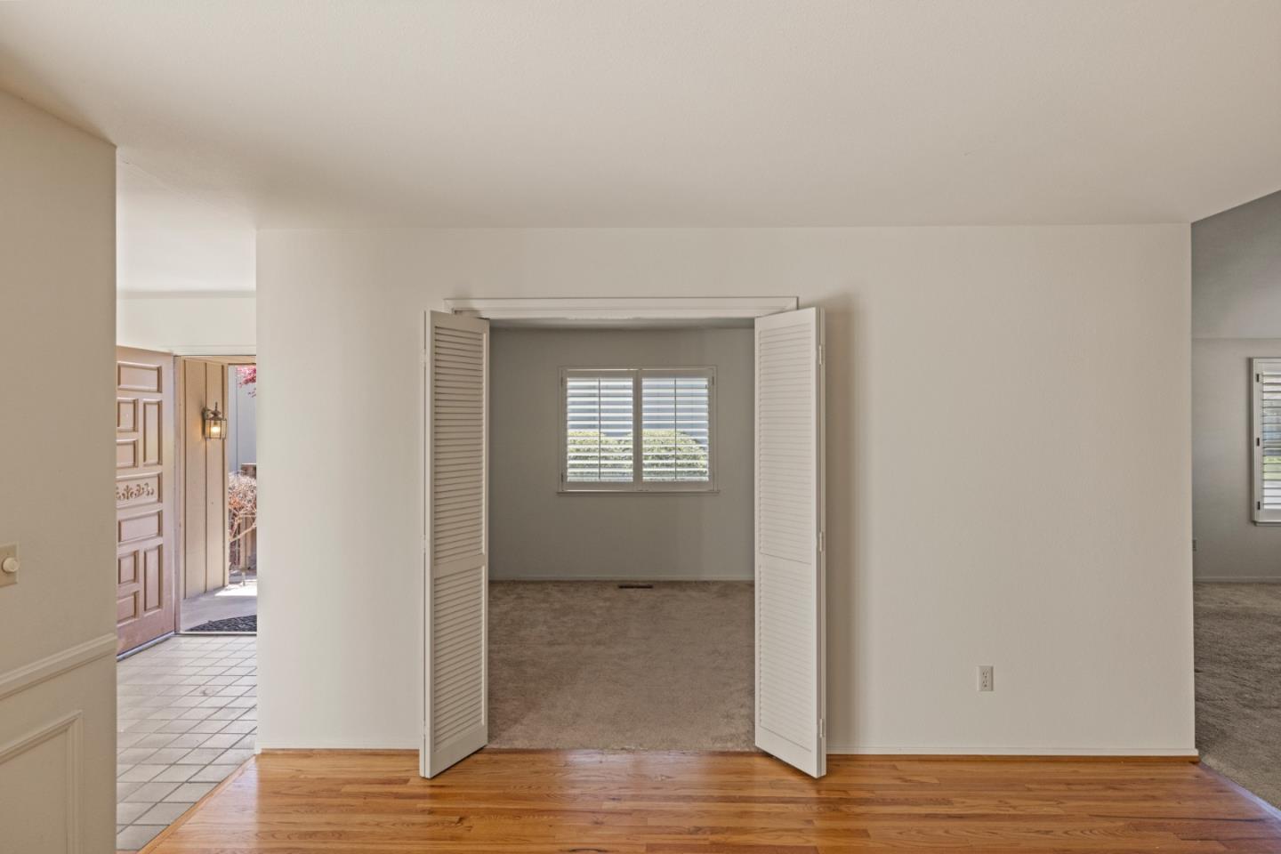 14220 Mountain Quail Road Salinas, CA 93908 - Photo 21 of 74 a view of an empty room with wooden floor and a window