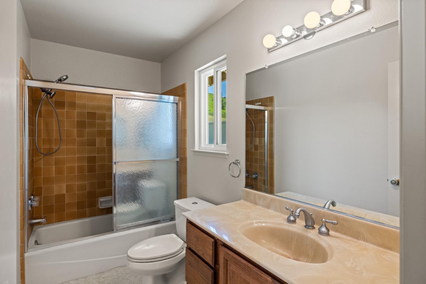 14220 Mountain Quail Road Salinas, CA 93908 - Photo 24 of 74 a bathroom with a sink a toilet and shower