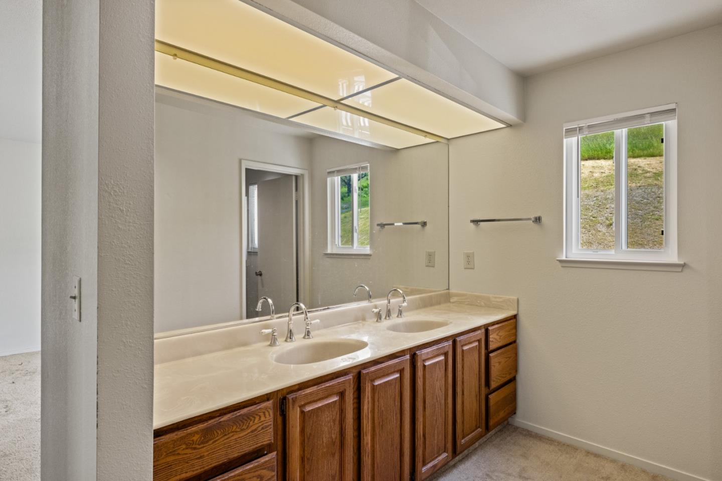 14220 Mountain Quail Road Salinas, CA 93908 - Photo 30 of 74 a bathroom with a sink and a mirror