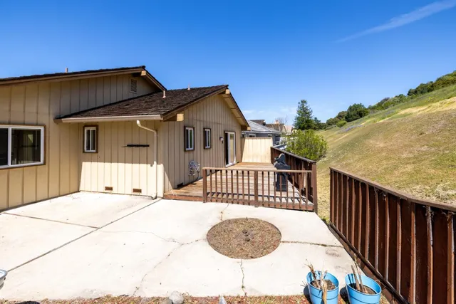 a view of a house with wooden fence