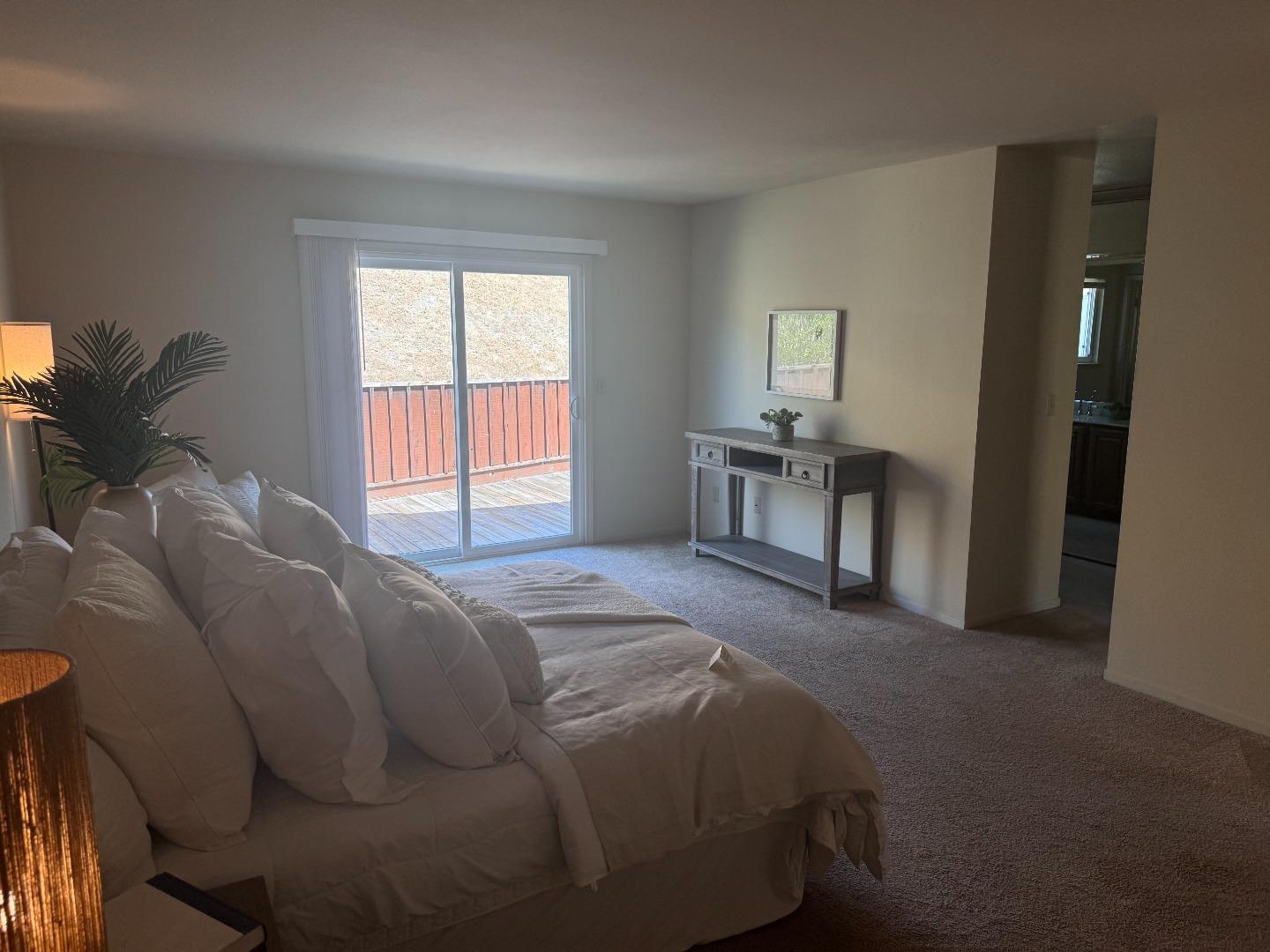 14220 Mountain Quail Road Salinas, CA 93908 - Photo 34 of 74 a bed sitting in a bedroom next to a window