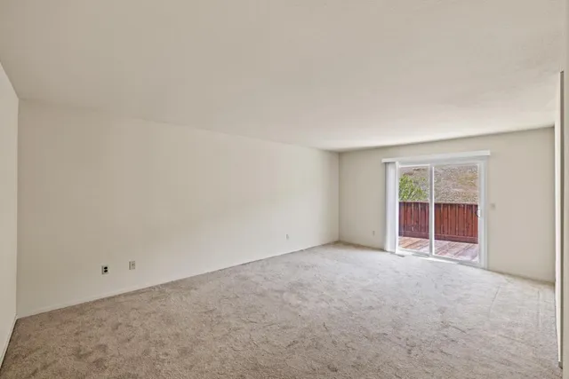 a living room with furniture a rug and wooden floor