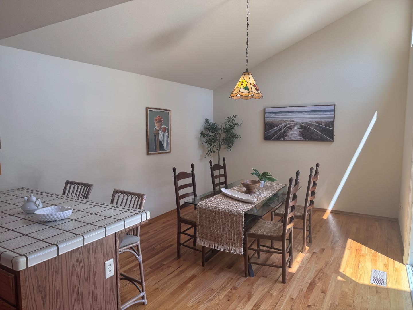 14220 Mountain Quail Road Salinas, CA 93908 - Photo 40 of 74 a view of a dining room with furniture wooden floor and a chandelier