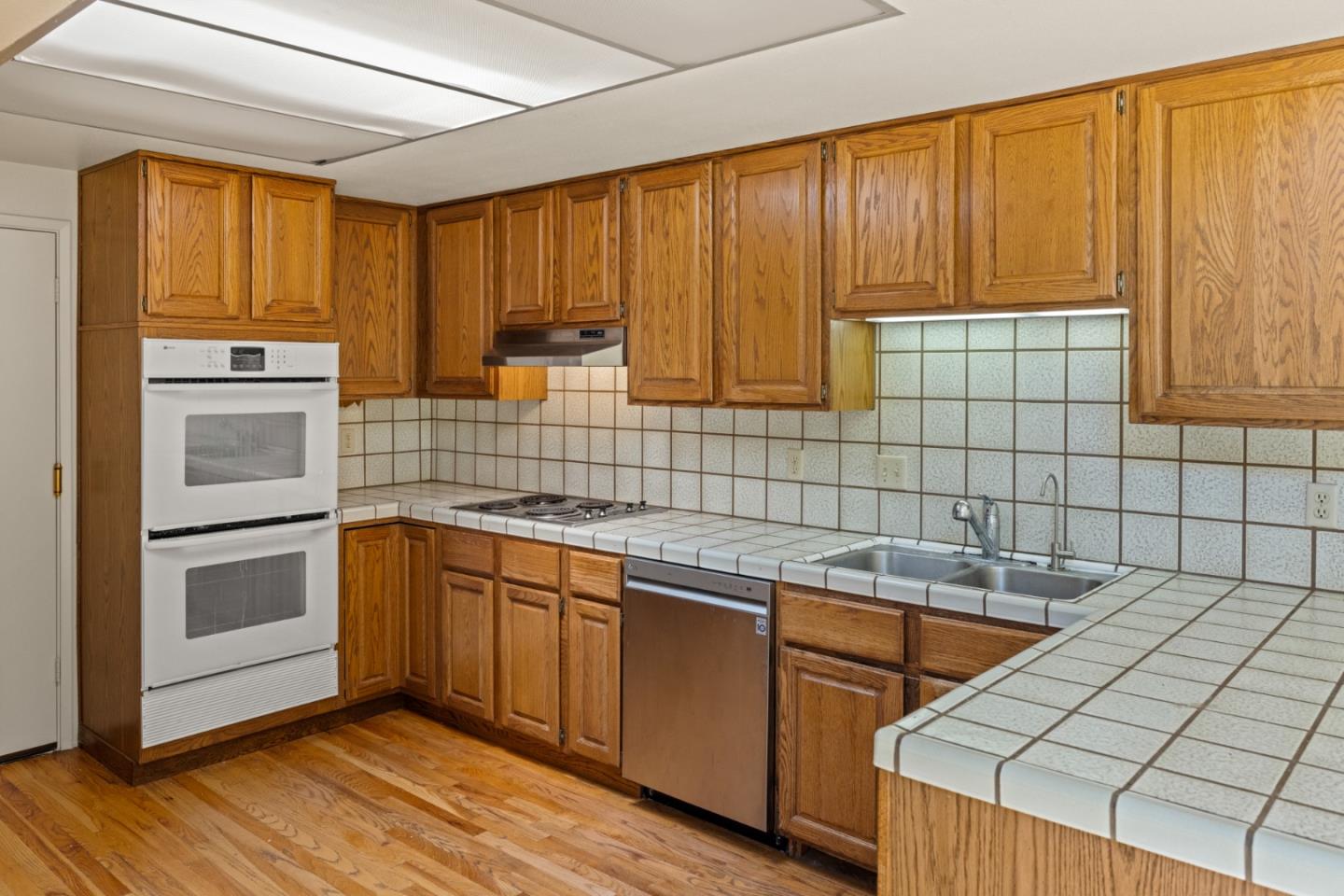 14220 Mountain Quail Road Salinas, CA 93908 - Photo 45 of 74 a kitchen with stainless steel appliances granite countertop a sink and cabinets