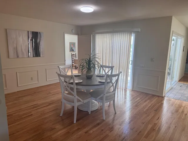 a front view of a house with a garden and plants
