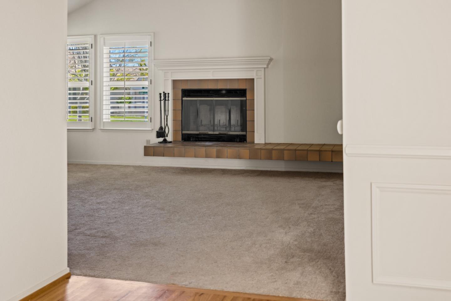 14220 Mountain Quail Road Salinas, CA 93908 - Photo 62 of 74 a living room with a fireplace and a window