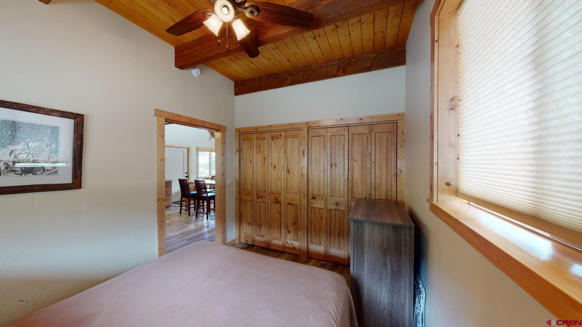 16800 Grange Road Paonia, CO 81428 - Photo 15 of 38 a bedroom with a bed and a chandelier