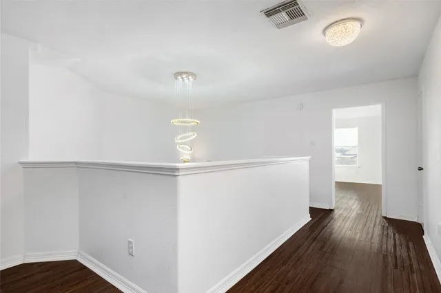 a view of a room with wooden floor
