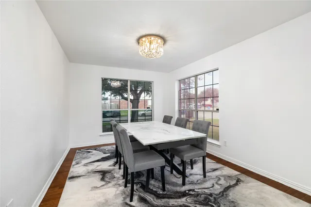 a view of a dining room with a table and chairs