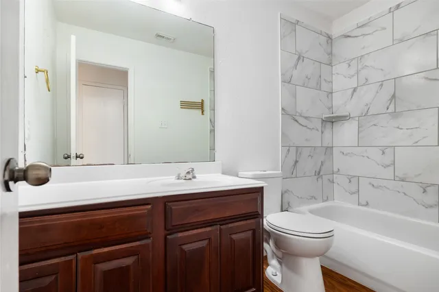 a bathroom with a sink a toilet and bathtub