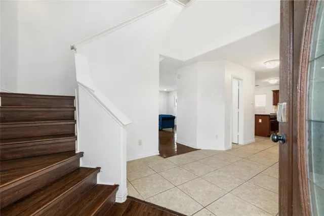 a view of a livingroom with wooden floor and stairs
