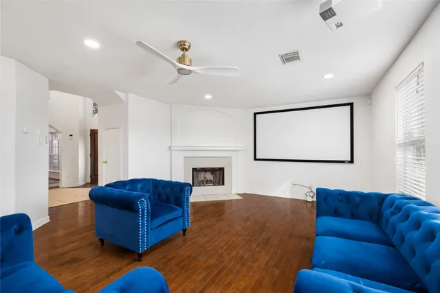 a living room with furniture wooden floor and a fireplace