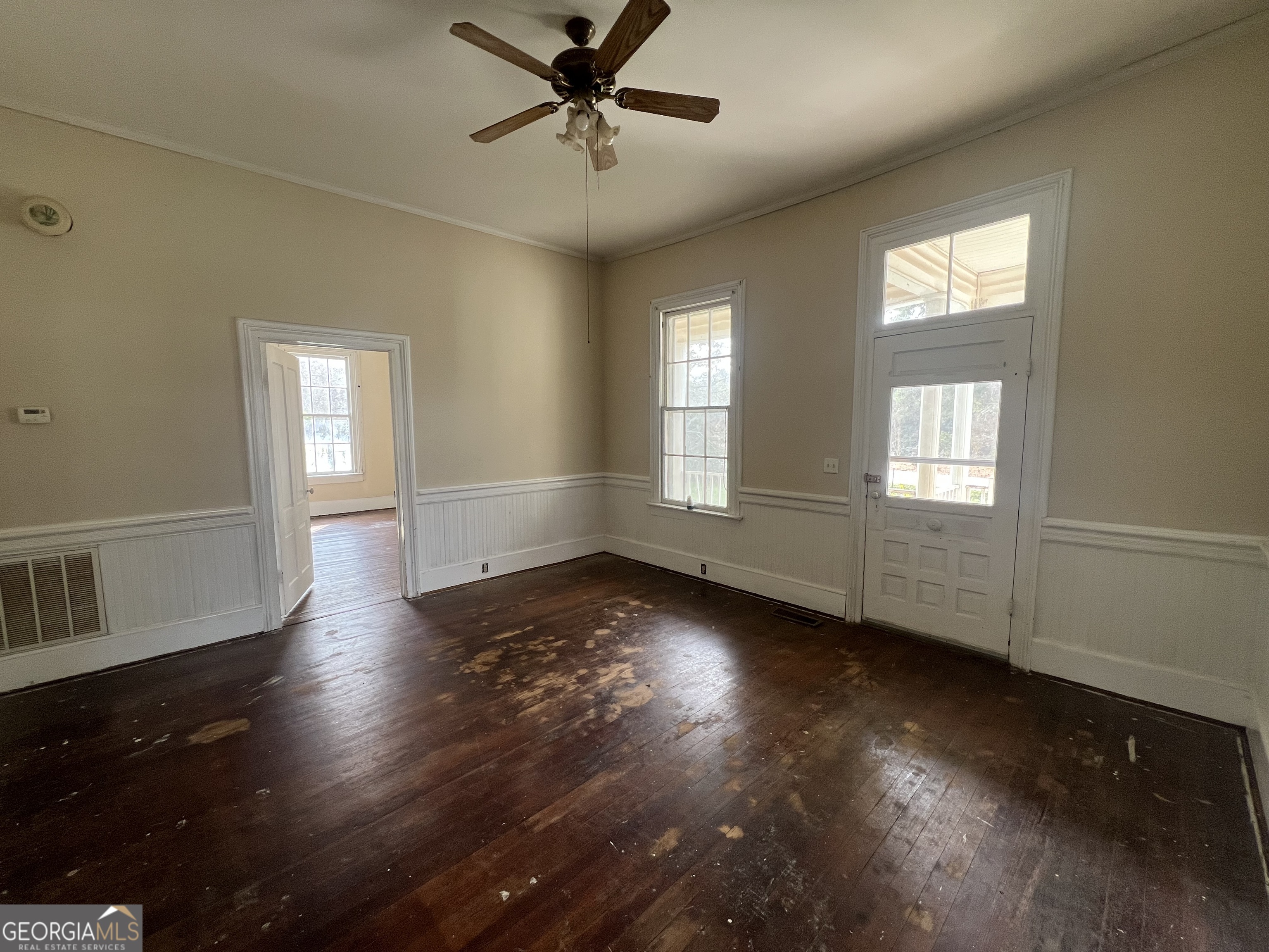 179 Independence Street Tignall, GA 30668 - Photo 2 of 21 a view of an empty room with wooden floor and a window