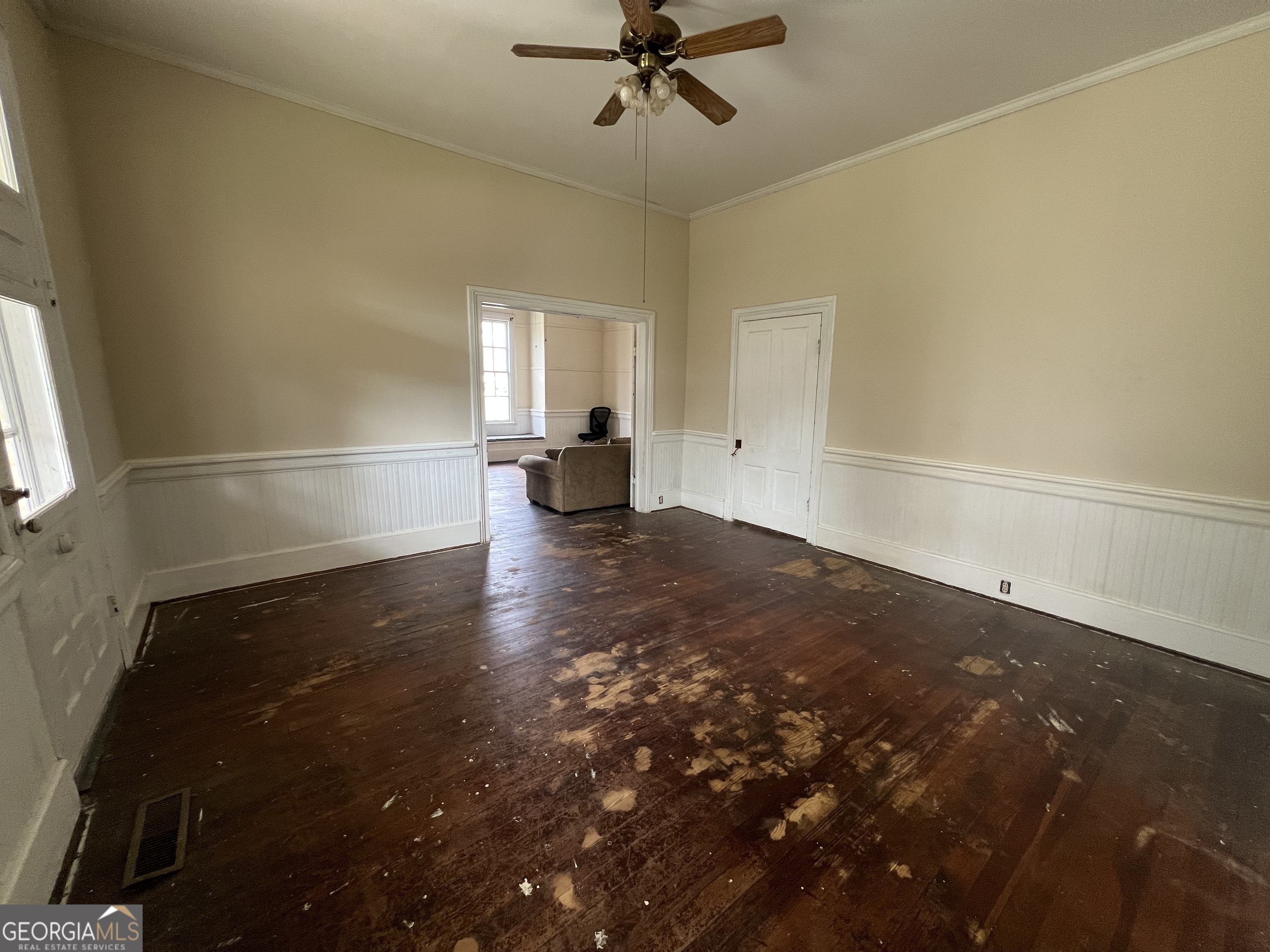 179 Independence Street Tignall, GA 30668 - Photo 3 of 21 a view of empty room with wooden floor and fan