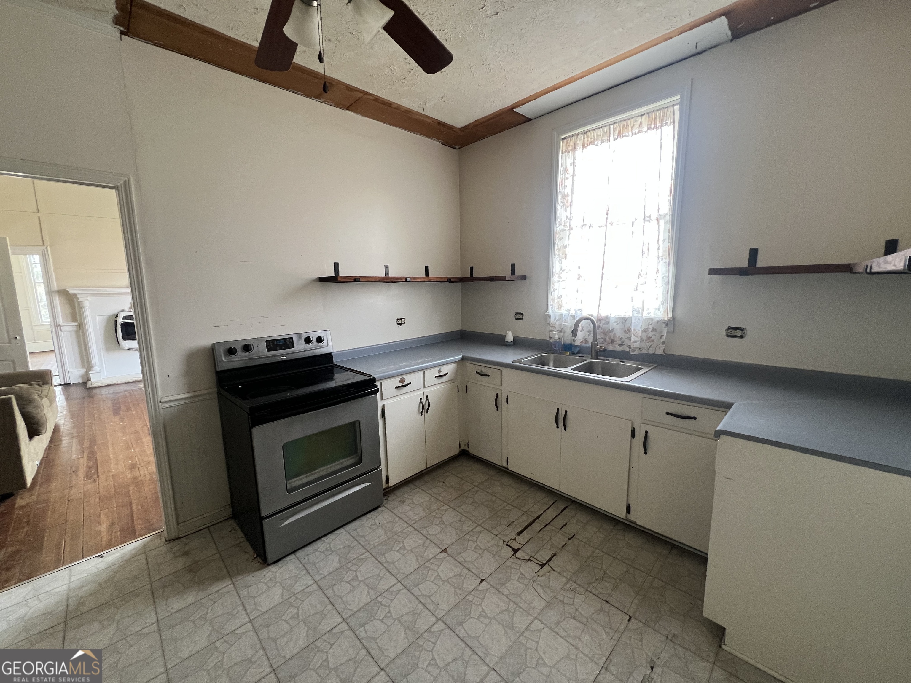 179 Independence Street Tignall, GA 30668 - Photo 7 of 21 a kitchen with a stove sink and a window