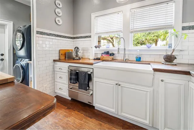 a kitchen with a stove a sink and a window