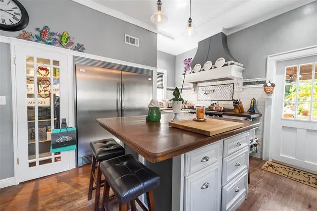 a kitchen with stainless steel appliances granite countertop a sink a stove and a refrigerator