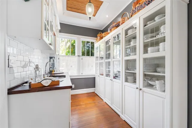 a view of a room with shelves and wooden floor