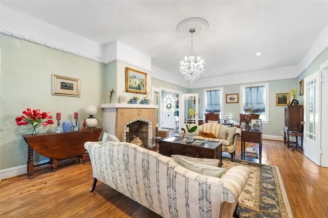 a living room with furniture and a chandelier