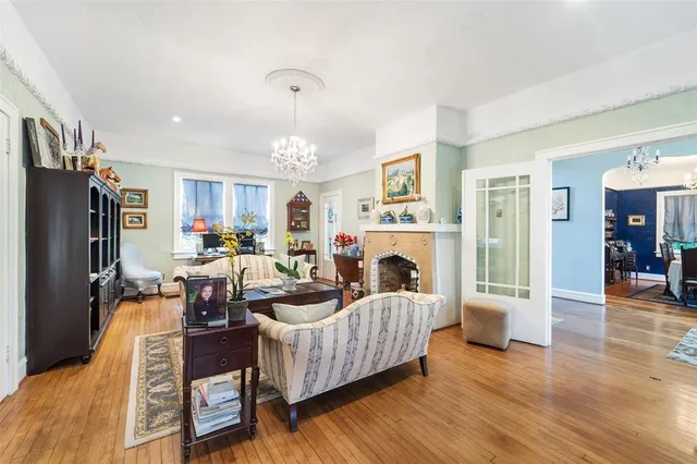a living room with fireplace furniture and a flat screen tv