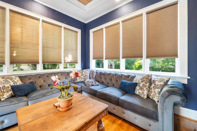 a living room with furniture and floor to ceiling windows