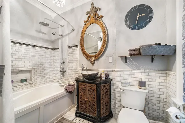 a bathroom with a toilet a sink and mirror
