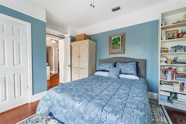 a bedroom with a bed and a book shelf