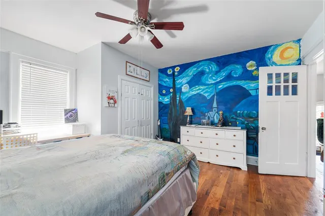 a bedroom with a bed and a dresser