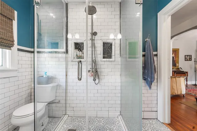 a bathroom with a toilet and shower